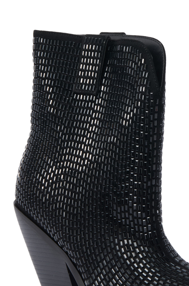 A close-up of the AZALEA WANG LAETITIA BLACK SPARKLE COWBOY BOOTIE featuring a black suede finish, geometric cutout pattern, side pull tab, and tapered high heel. The design gives a grid-like texture to the bootie’s surface. 5