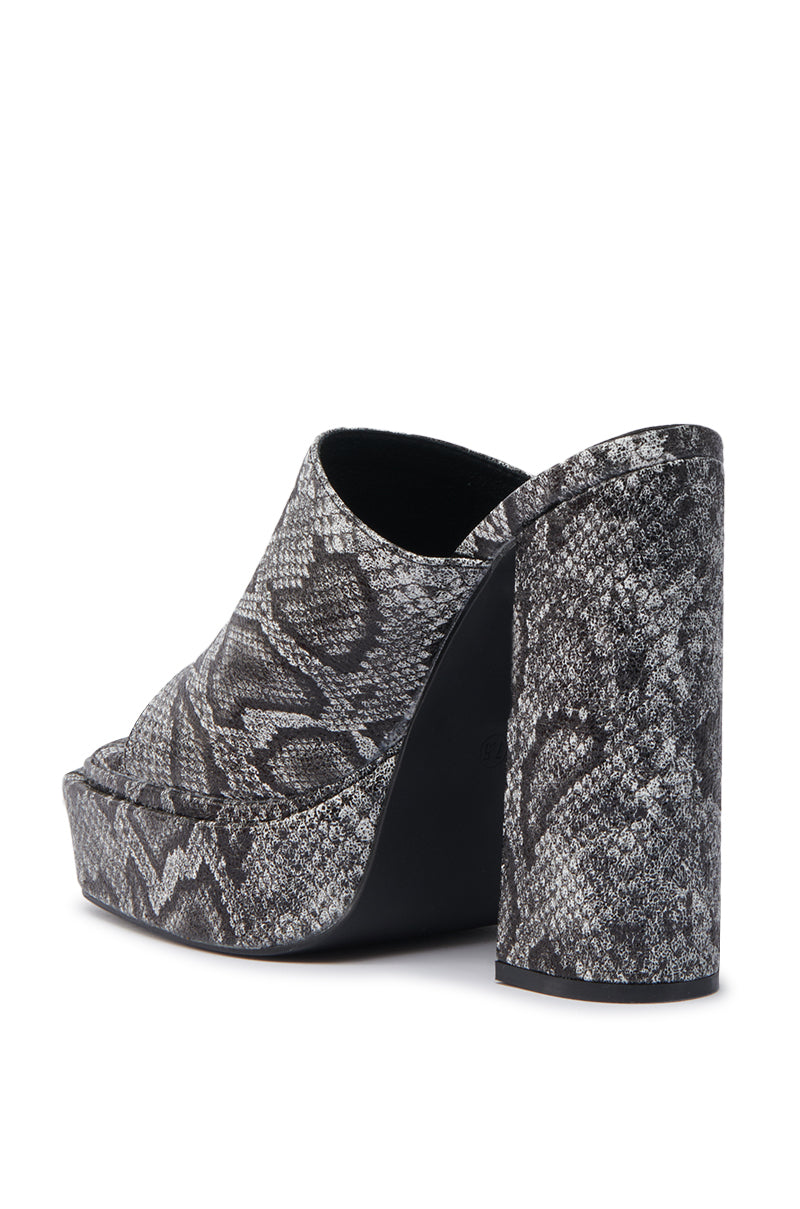 The AKIRA LAMONT SNAKE SANDAL CHUNKY PLATFORM is a chunky, high-heeled mule made of faux leather in a gray and black snakeskin pattern, shown from the back and side.