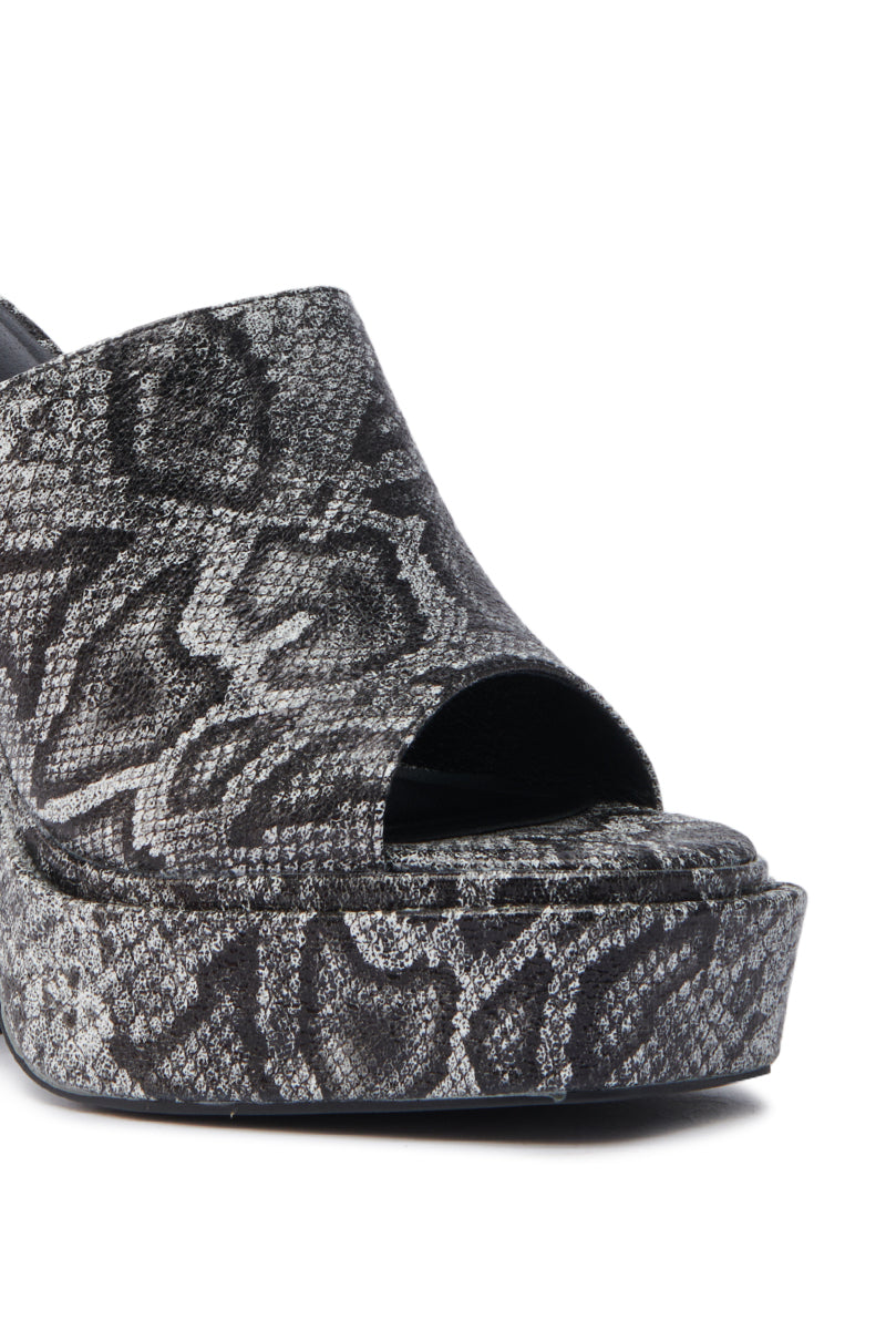 The AKIRA LAMONT SNAKE SANDAL CHUNKY PLATFORM showcases an open-toe design with a chunky platform sole and a black and gray faux snakeskin pattern.