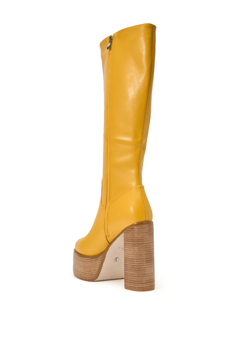 The AZALEA WANG LANDRY YELLOW PU WOOD STACK PLATFORM BOOT is a knee-high, yellow boot with a side zipper and thick wooden block heel, photographed on a white background—ideal for those who love statement boots. 5