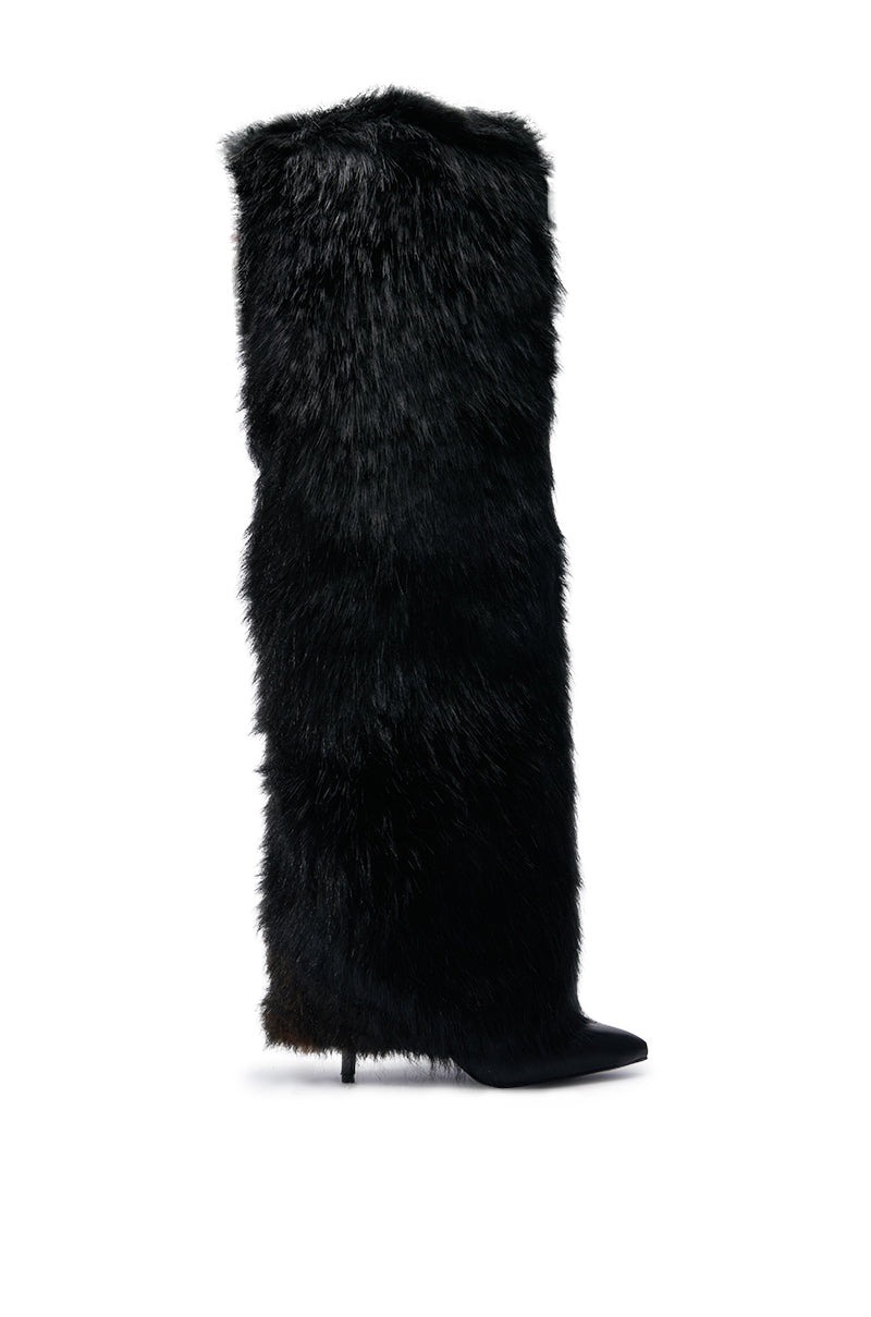 The AZALEA WANG LANGDON BLACK BOOT, a knee-high design adorned with luxurious black faux fur, boasts a pointed toe and an elegant stiletto heel, beautifully presented against a pristine white background.