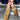Someone walks down a city street in the AZALEA WANG LANGDON BROWN THIGH HIGH FUR LUXE BOOT, paired with orange and blue shorts and a white crop top, with a blue SUV visible in the background.