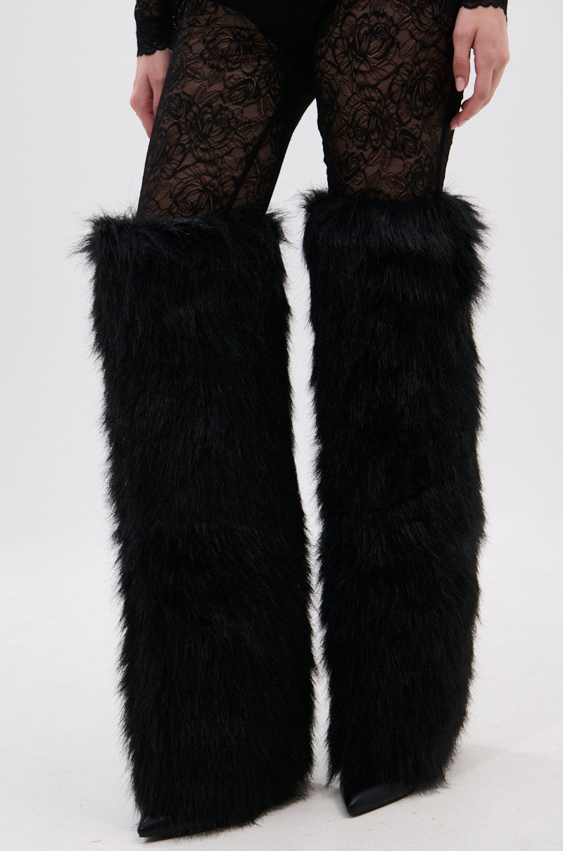 A person wears the AZALEA WANG LANGLEYE BLACK THIGH-HIGH FUR LUXE BOOT, styled on a white background.