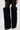 A person wears the AZALEA WANG LANGLEYE BLACK THIGH-HIGH FUR LUXE BOOT, styled on a white background.