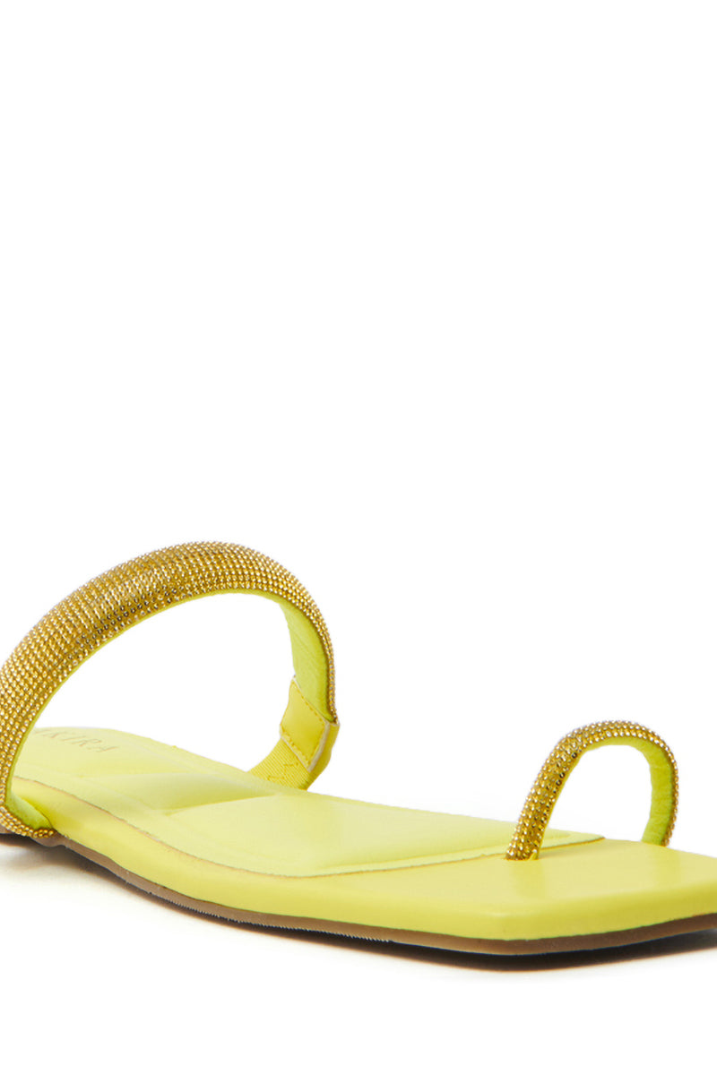 The AKIRA LAVEDA YELLOW EMBELLISHED FLAT SANDAL is a faux leather sandal with a toe loop design, featuring thin straps adorned with shiny rhinestones and a slightly cushioned neon-inspired flat sole for comfort.