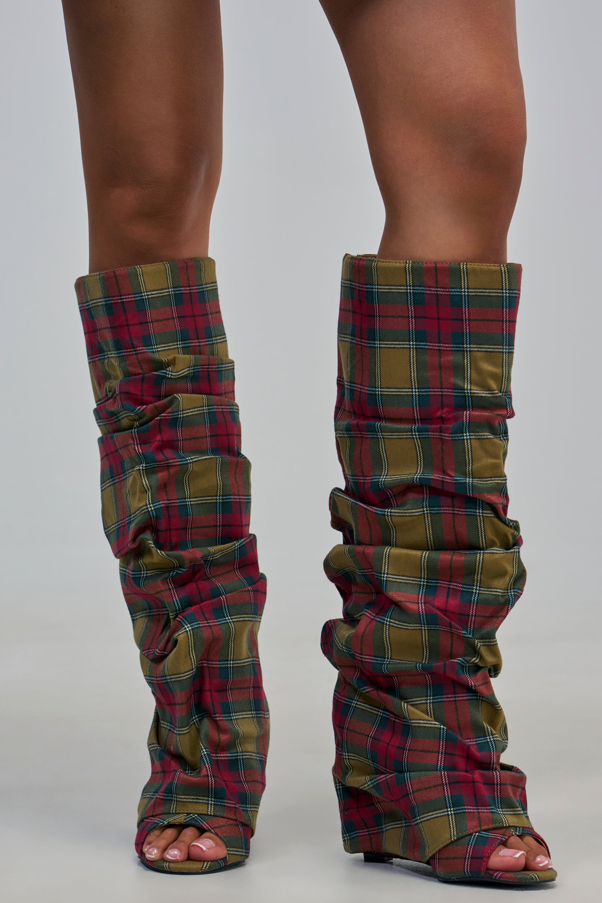 AZALEA WANG LAVINIA PLAID SLOUCHY WEDGE BOOTS featuring a red and green plaid pattern, knee-high length, open-toe design, and a slouchy, gathered fabric shaft for an ideal fall streetwear look.