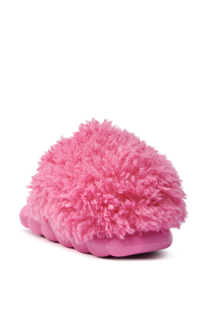 The AZALEA WANG LAWSON PINK SLIPPER features a cozy faux fur upper with a vibrant shaggy texture, angled to showcase its thick flatform sole and inviting design.