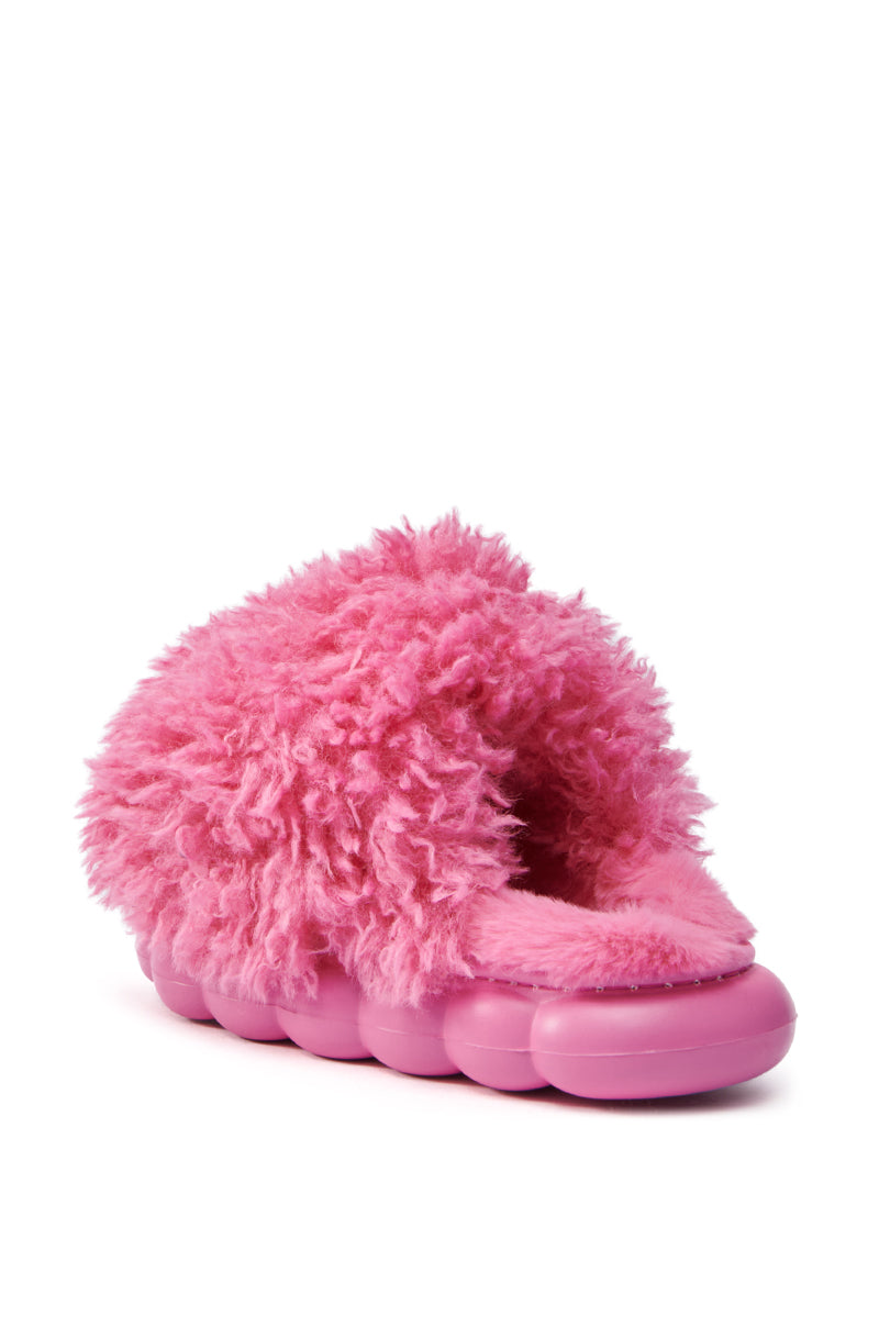 The AZALEA WANG LAWSON PINK SLIPPER features a fluffy faux fur upper and a chunky, cushioned flatform sole designed for ultimate comfort.