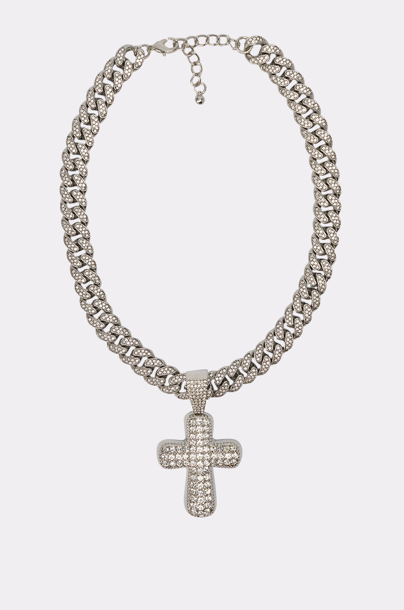 The GIMME NECKLACE features a thick pavé Cuban link chain and a large, sparkling rhinestone cross pendant, shown on a plain white background. 4