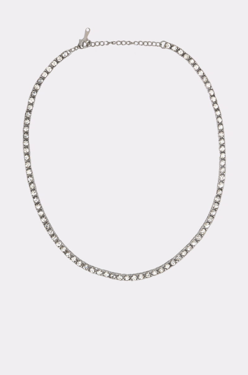 The GIMME NECKLACE is a delicate layered set with a silver chain and small, round clear gemstones evenly spaced along its length, displayed on a plain white background. 5