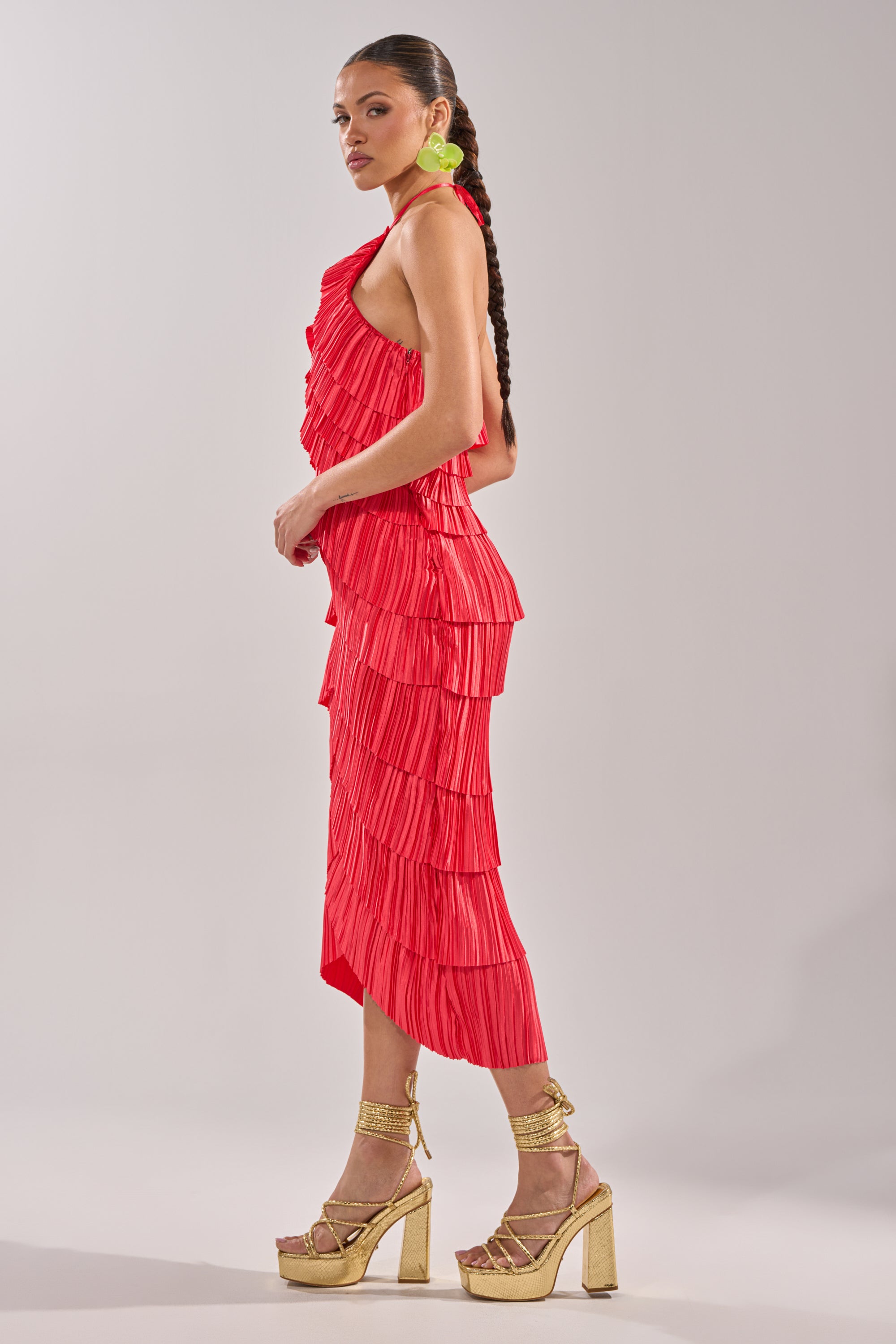 A woman in the GIVE IT TO ME BABY SATIN MAXI DRESS, a pleated red halter-neck maxi dress. 5