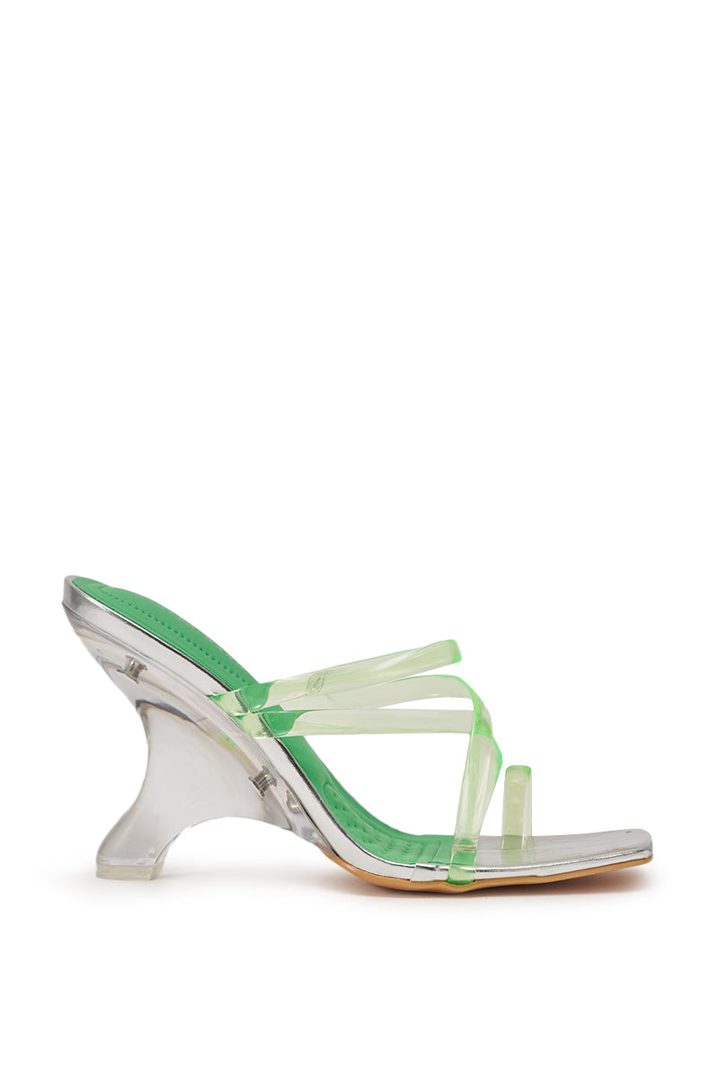 The AZALEA WANG LEMUEL GREEN AND SILVER WEDGE SANDAL features a high heel, open square toe, translucent green insole, clear green straps, and a sculpted transparent wedge heel, shown against a white background. 3