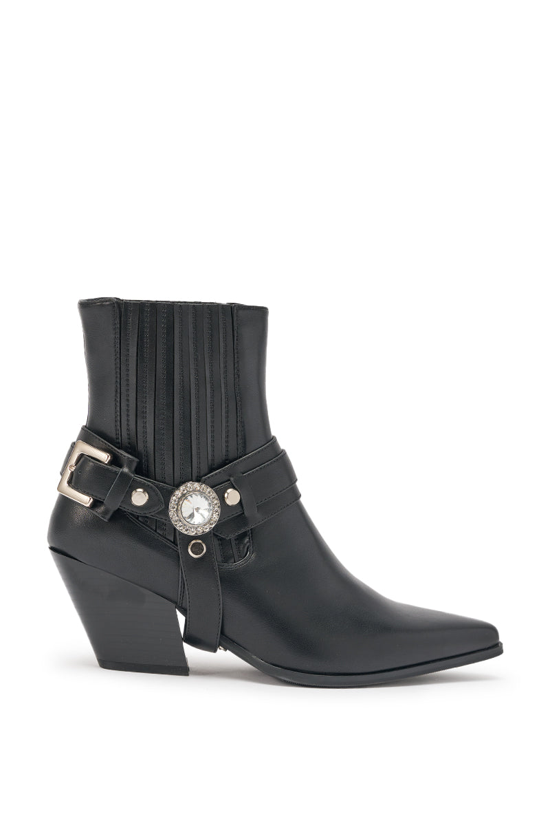 The AZALEA WANG LENKOV BLACK WESTERN BOOT is a black mid-calf bootie with a pointed toe, chunky angled heel, vertical stitching, and a decorative side strap featuring a silver buckle and round jewel accent. 4