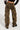 Dressed in THE ULTIMATE LEOPARD CARGO PANT with a relaxed silhouette, featuring a loose fit and multiple pockets, and complemented by black chunky boots, the individual stands facing away. Their top showcases a black and red color scheme against a plain white background.