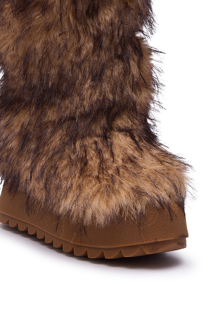 Close-up of the AZALEA WANG LEOPOLD BROWN MULTI FLAT FUR BOOT featuring brown faux fur with dark highlights and a thick textured rubber sole. These boots appear warm and rugged, perfect for cold weather.