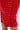 Close-up of the PURE JOY MIDI DRESS WITH DRAMATIC SLEEVE IN RED, showcasing its bold color, bodycon fit, and a striking vertical ruffle detail with neatly folded pleats along the side seam.