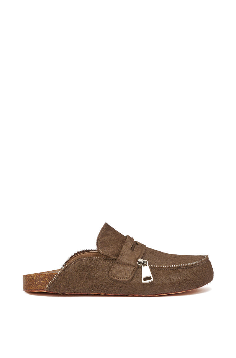 The AZALEA WANG LIMERICK CHOCOLATE METAL EMBELLISHMENT FLAT is a chocolate brown suede-like slip-on mule with metal embellishments, a visible zipper detail, cork insole, and open back—ideal for slip-on loafer fans. 3