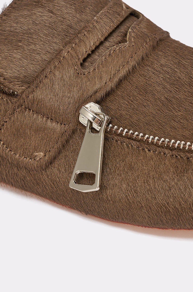 Close-up of the AZALEA WANG LIMERICK CHOCOLATE METAL EMBELLISHMENT FLAT, featuring chocolate brown calf hair, a metallic zipper with large pull tab, detailed stitching, and a soft texture. 6