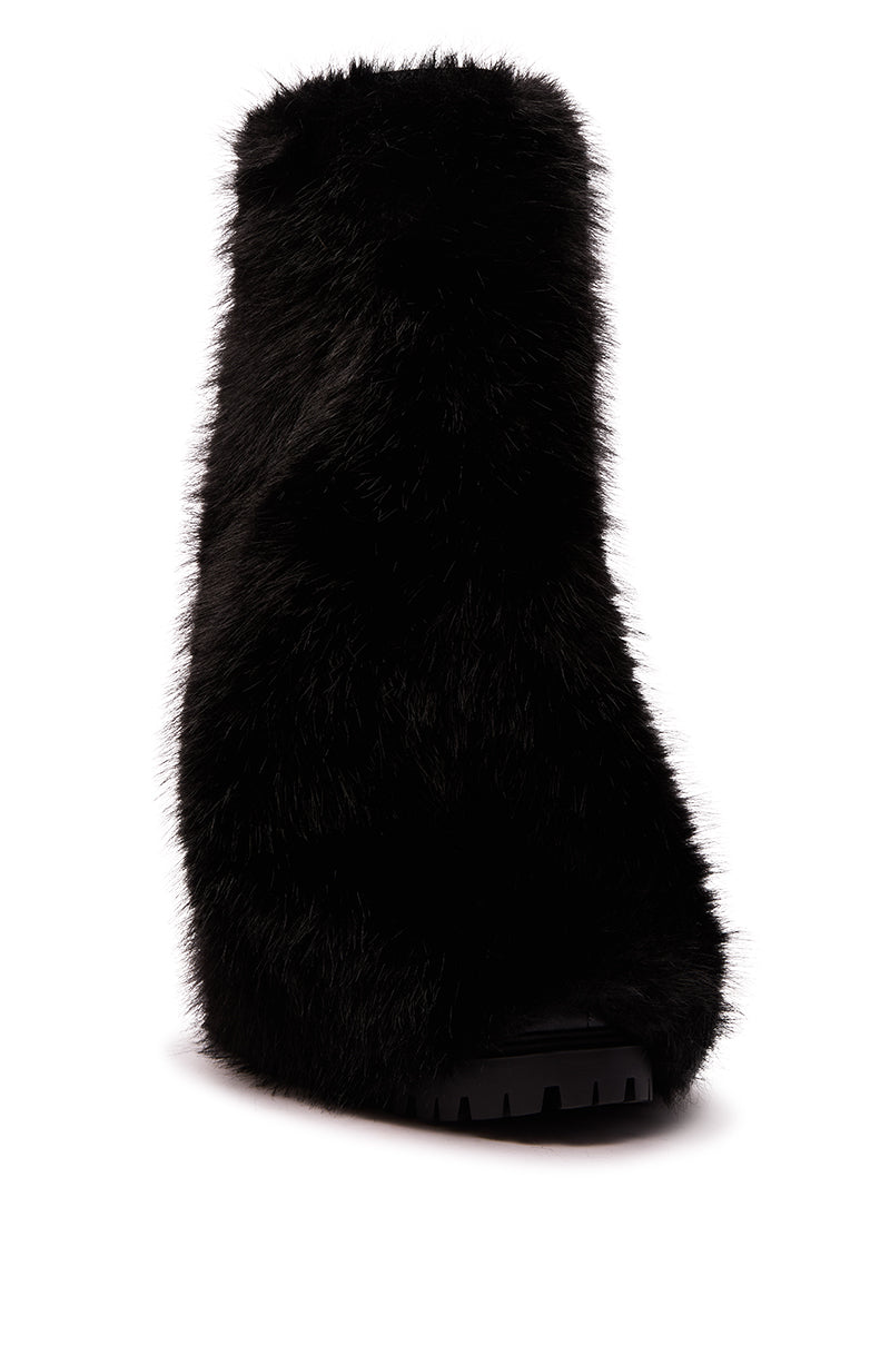 The AZALEA WANG LISBOA BLACK FUR FOLD OVER BOOT is a single black, soft faux fur mid-calf boot with a chunky sole and closed toe, blending style and comfort—an ideal addition to your boots collection. Photographed against a white background.