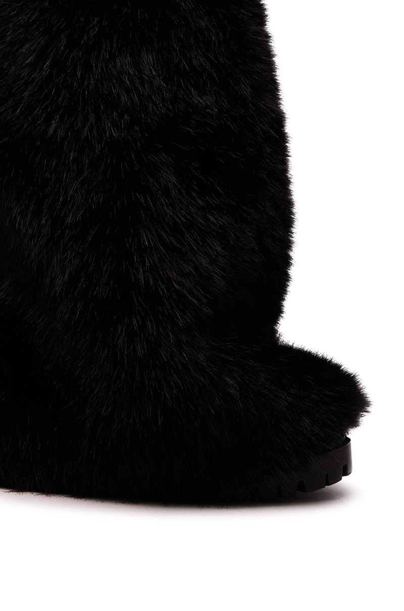 Close-up of the AZALEA WANG LISBOA BLACK FUR FOLD OVER BOOT, featuring black faux leather, chunky textured sole, and fold-over fur detail, styled mid-calf against a crisp white background.