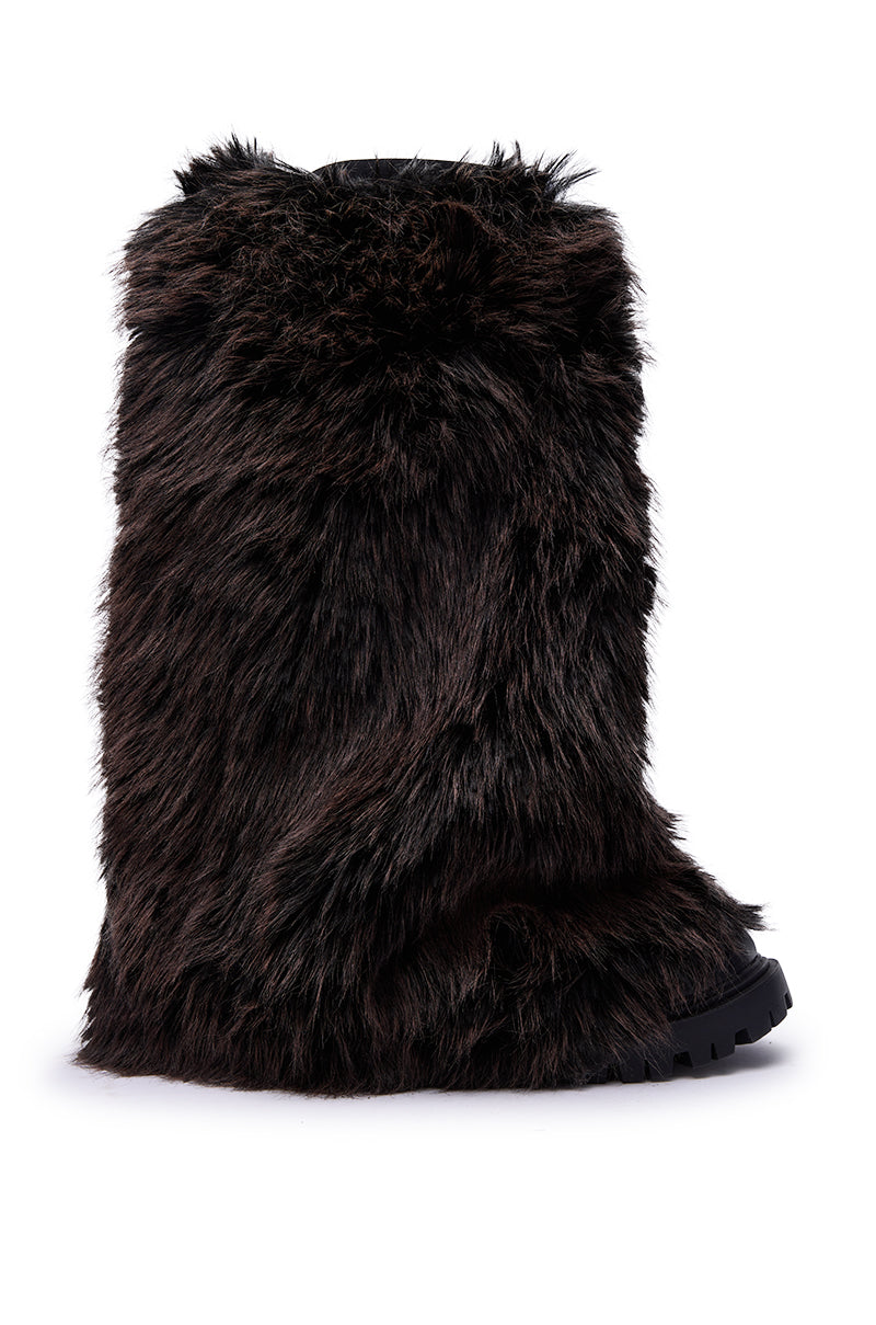 The AZALEA WANG LISBOA BROWN FUR FOLD OVER BOOT features a tall silhouette, shaggy brown faux fur, and a chunky heel, showcased against a white background.