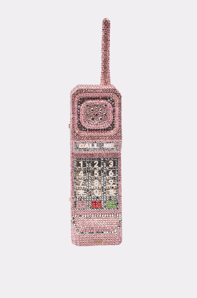 The HIT MY LINE BLING PURSE, a vintage-inspired handbag shaped like a brick cell phone and covered in pink rhinestones with "CALL ME" above the keypad, is shown against a plain white background. 3