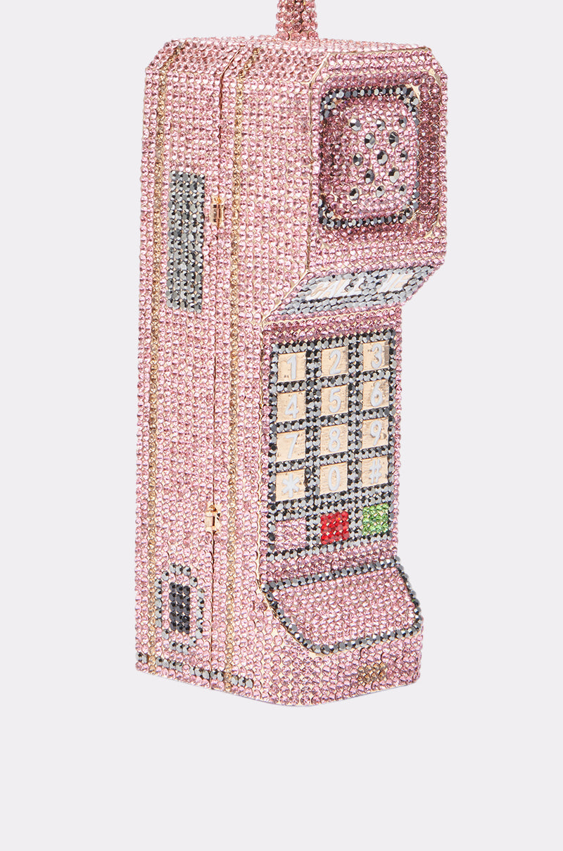 The HIT MY LINE BLING PURSE is a Y2K-inspired handbag shaped like a vintage cell phone, adorned with pink, silver, and gold rhinestones, and detailed with a keypad, antenna, and speaker. 5