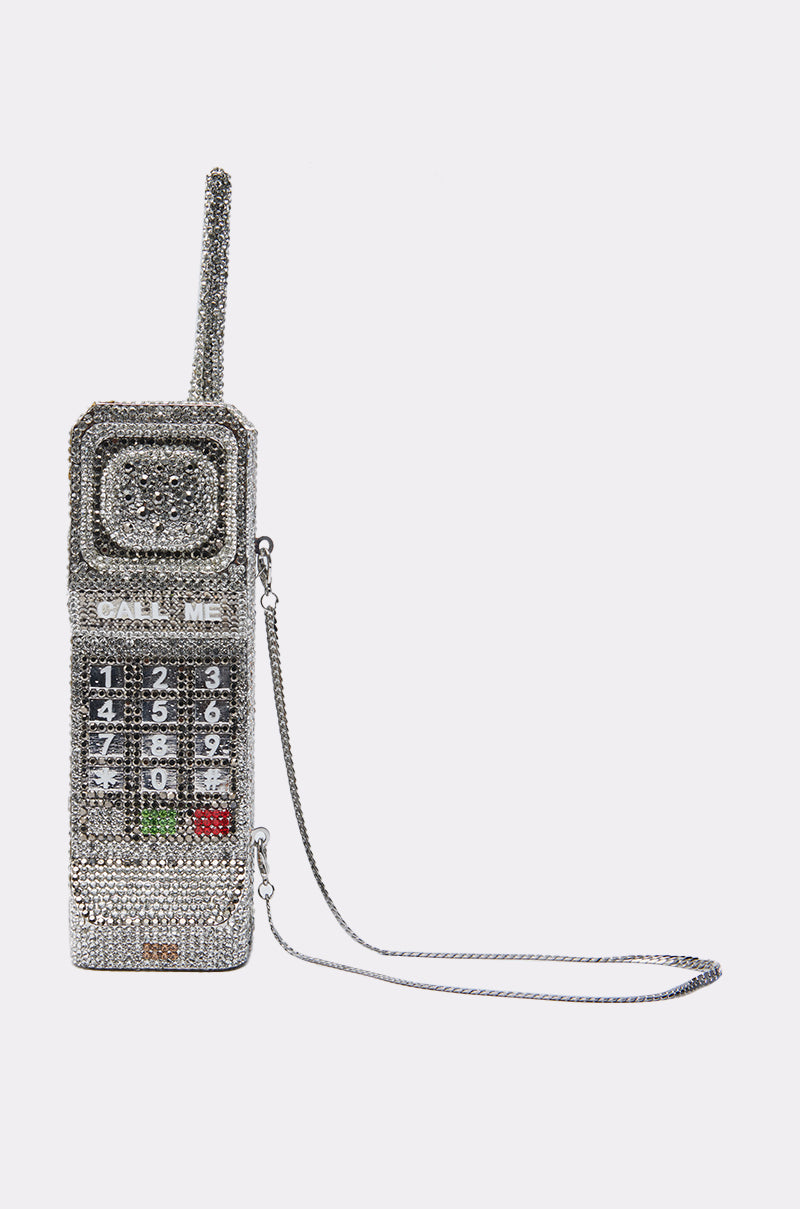 The CALL ME BLING CLUTCH is a rhinestone handbag shaped like a vintage brick cell phone, complete with keypad, screen, antenna, sparkling bling accents, and a silver chain strap. 9