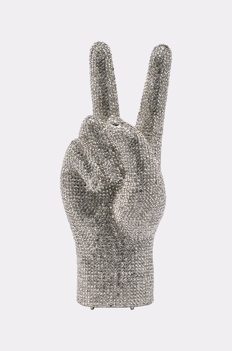 The PEACE BLING PURSE is a silver, bejeweled handbag shaped like a hand making a peace sign, set against a plain light background. 2