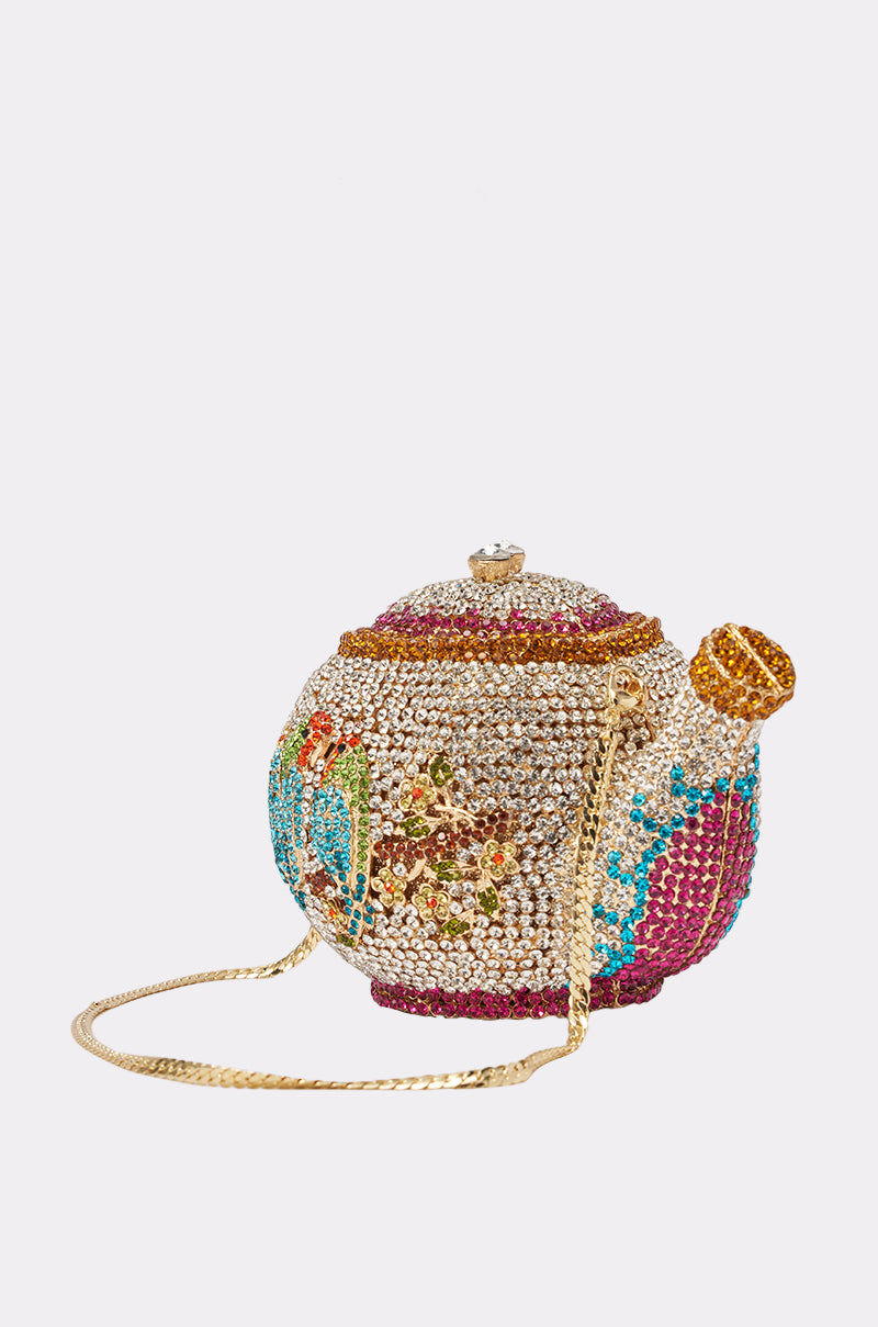 The WHATS THE TEA BLING PURSE is a jeweled teapot-shaped handbag adorned with colorful crystal floral patterns, a gold chain strap, and intricate details—an eye-catching party accessory. 3