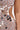 A close-up of the QUEEN OF EVERYTHING MIRRORED MAXI DRESS IN SILVER, featuring sheer nude fabric adorned with silver sequins, mirrored triangles, and a side cut-out detail.