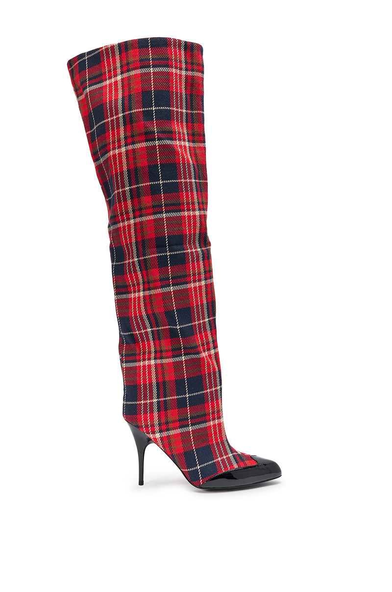 The AKIRA GOLD LOCHANA MULTI PLAID FLANNEL SEXY BOOT is a tall, over-the-knee boot with a pointed toe, stiletto heel, and slouchy upper in bold red and black plaid flannel for standout tartan style.