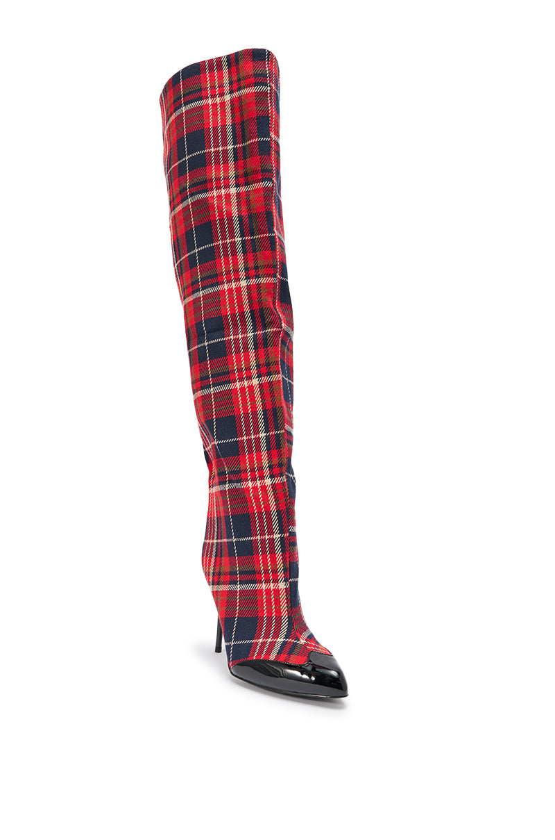 The AKIRA GOLD LOCHANA MULTI PLAID FLANNEL SEXY BOOT is a knee-high, pointed-toe stiletto boot in red, black, and yellow plaid flannel with a glossy black toe cap.