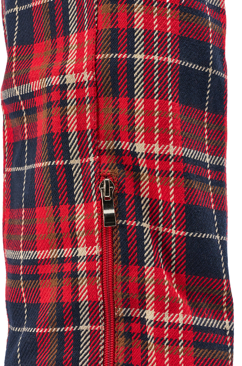 A close-up of the AKIRA GOLD LOCHANA MULTI PLAID FLANNEL SEXY BOOT fabric, showcasing its red, navy, and white plaid pattern with a small zipper and visible material texture.