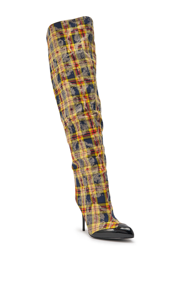 The AKIRA WANG LOCHANA MULTI YELLOW PLAID FLANNEL SEXY BOOT, a single plaid thigh-high with yellow, black, and red checks, a pointed black toe, and high stiletto heel, is displayed against a white background. 5
