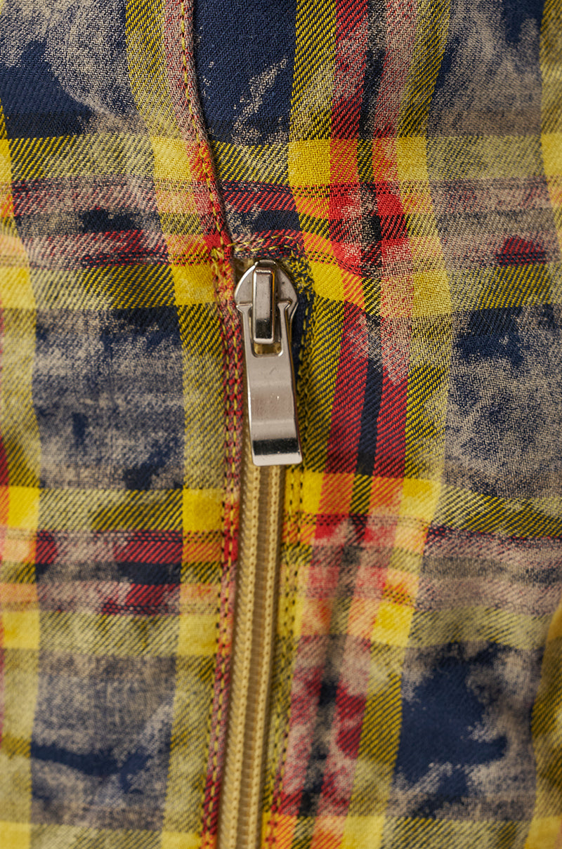 Close-up of a metal zipper on the AKIRA WANG LOCHANA MULTI YELLOW PLAID FLANNEL SEXY BOOT, showing worn yellow, red, and blue plaid fabric with the zipper partially open at the center. 7