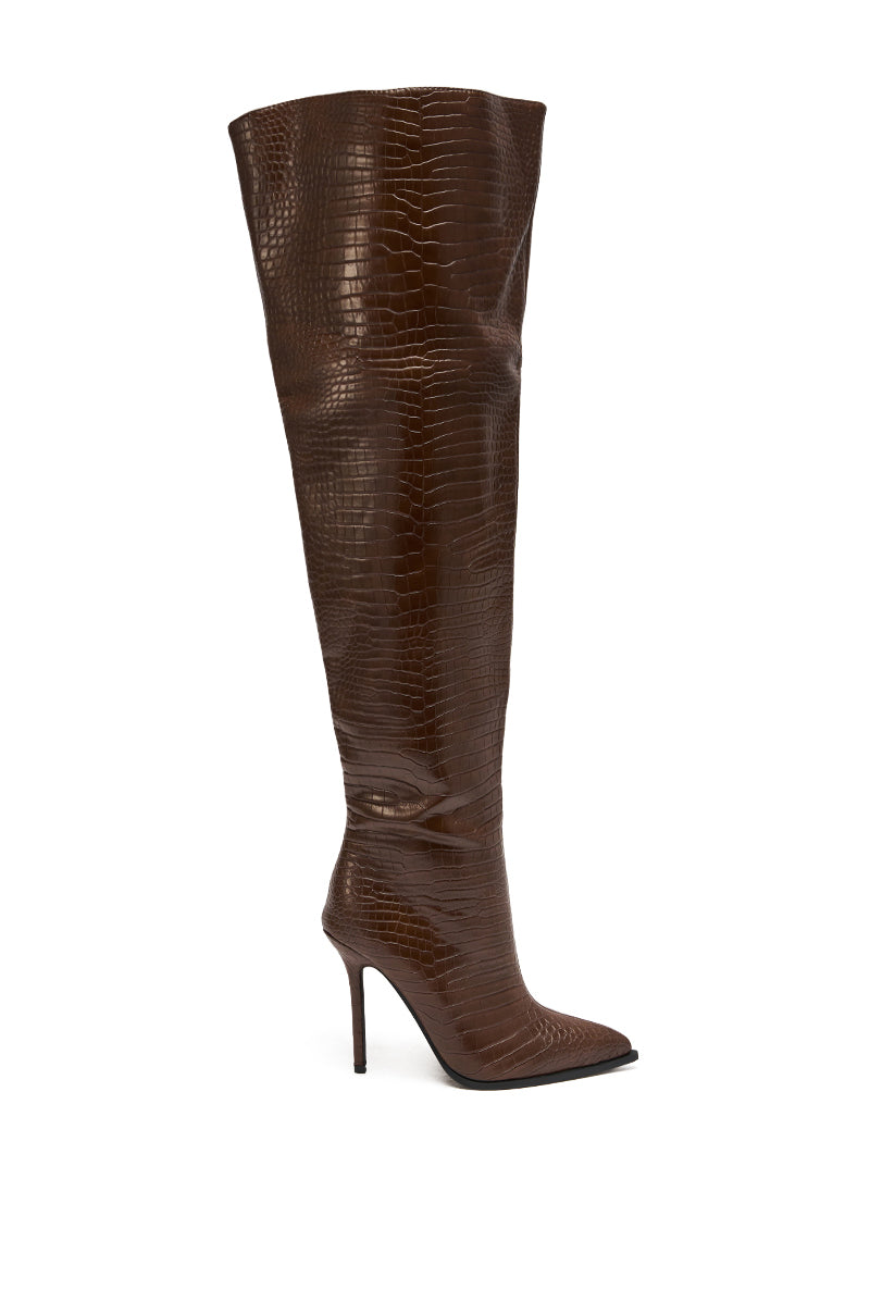 The AZALEA WANG LORAH CROC BROWN BOOT is a tall, thigh-high faux leather boot with brown crocodile print, pointed toe, and high stiletto heel, displayed in side view against a white background.