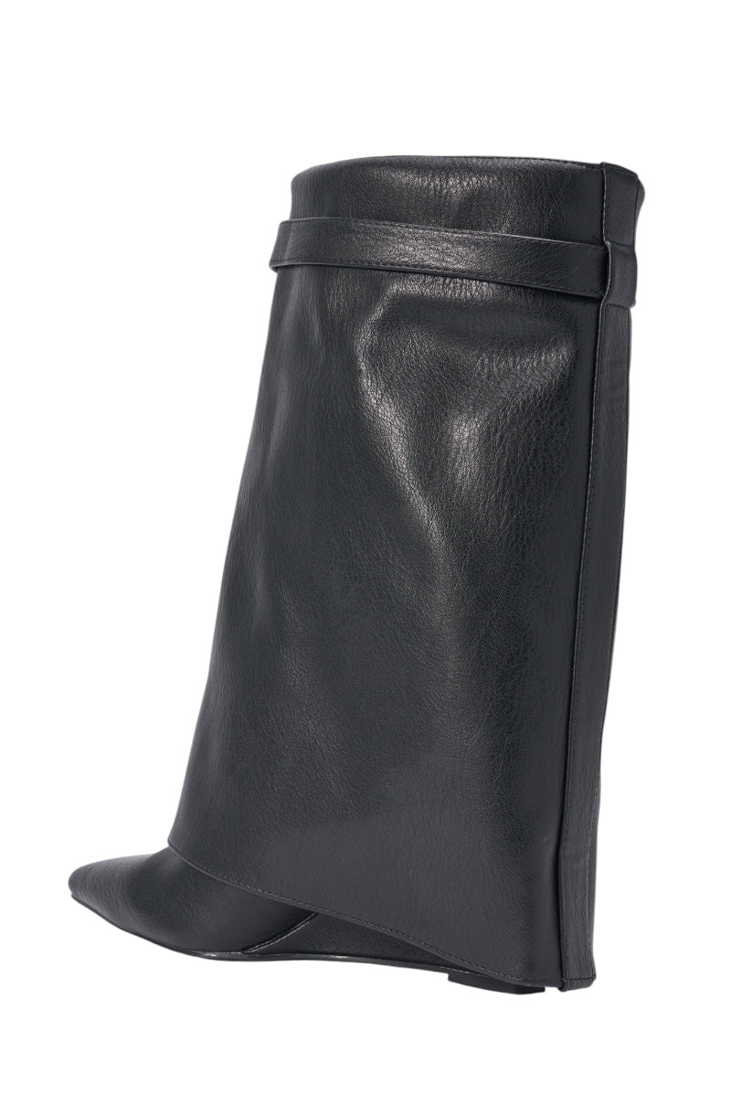 The AZALEA WANG LOUISA BLACK PU WEDGE BOOTIE is a unique black faux leather bootie featuring a high, wide foldover shaft and an angular sculptural design with a sharply curved toe, shown against a white background. 4