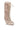 The AZALEA WANG LOURDANNE IVORY FUR LACE UP BOOT is a tall, plush faux fur ivory boot with light laces crisscrossing the front, a side buckle detail, and a rounded toe.