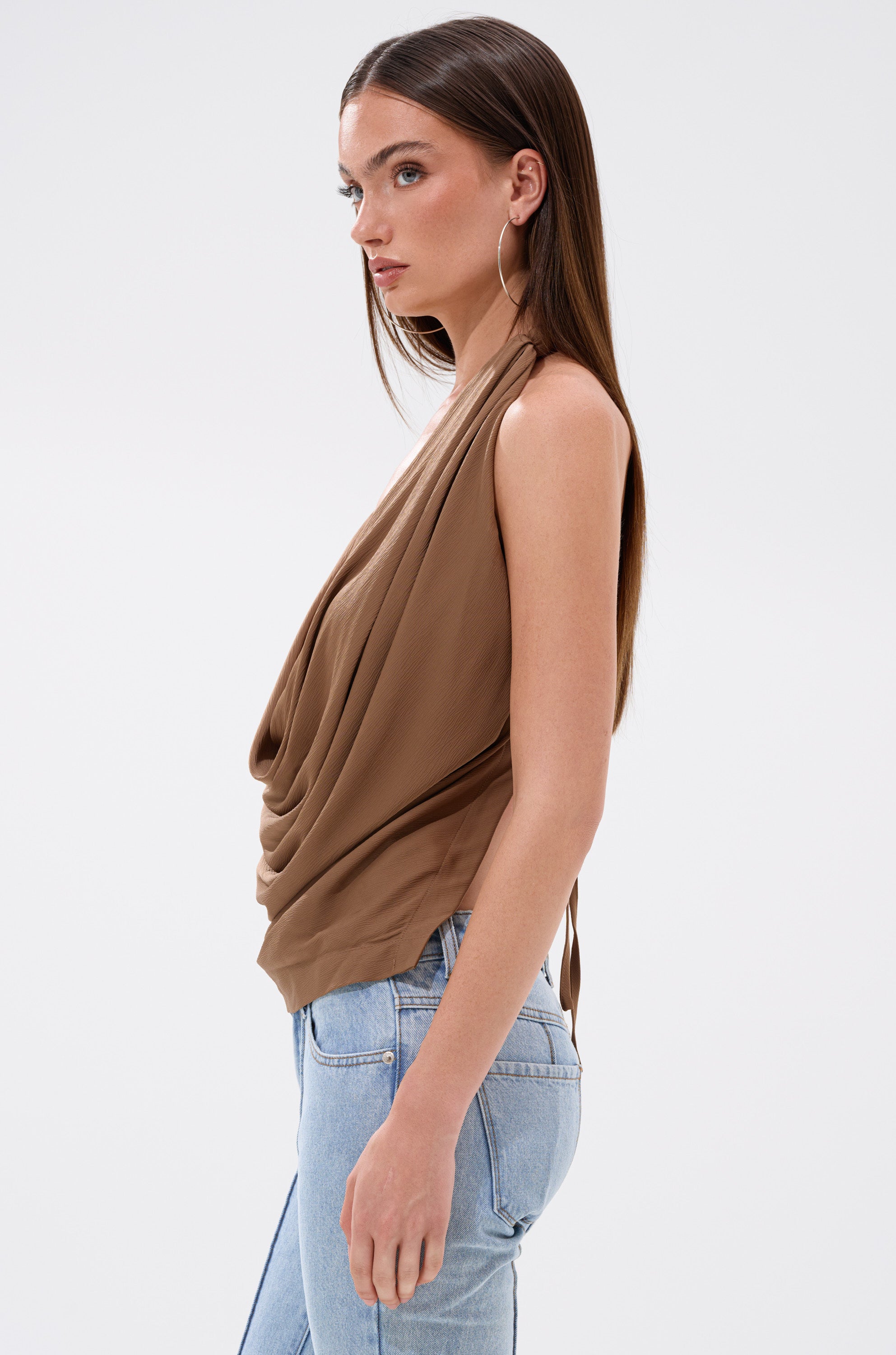 A woman wearing the LEXI SATIN COWL NECK BLOUSE in brown.