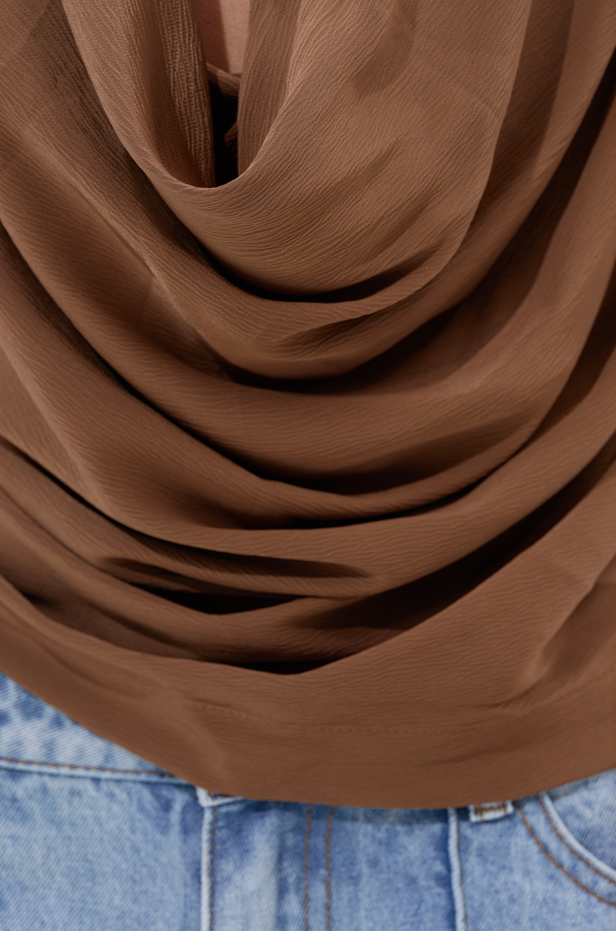 A close-up of the LEXI SATIN COWL NECK BLOUSE in brown, highlighting its smooth satin texture.