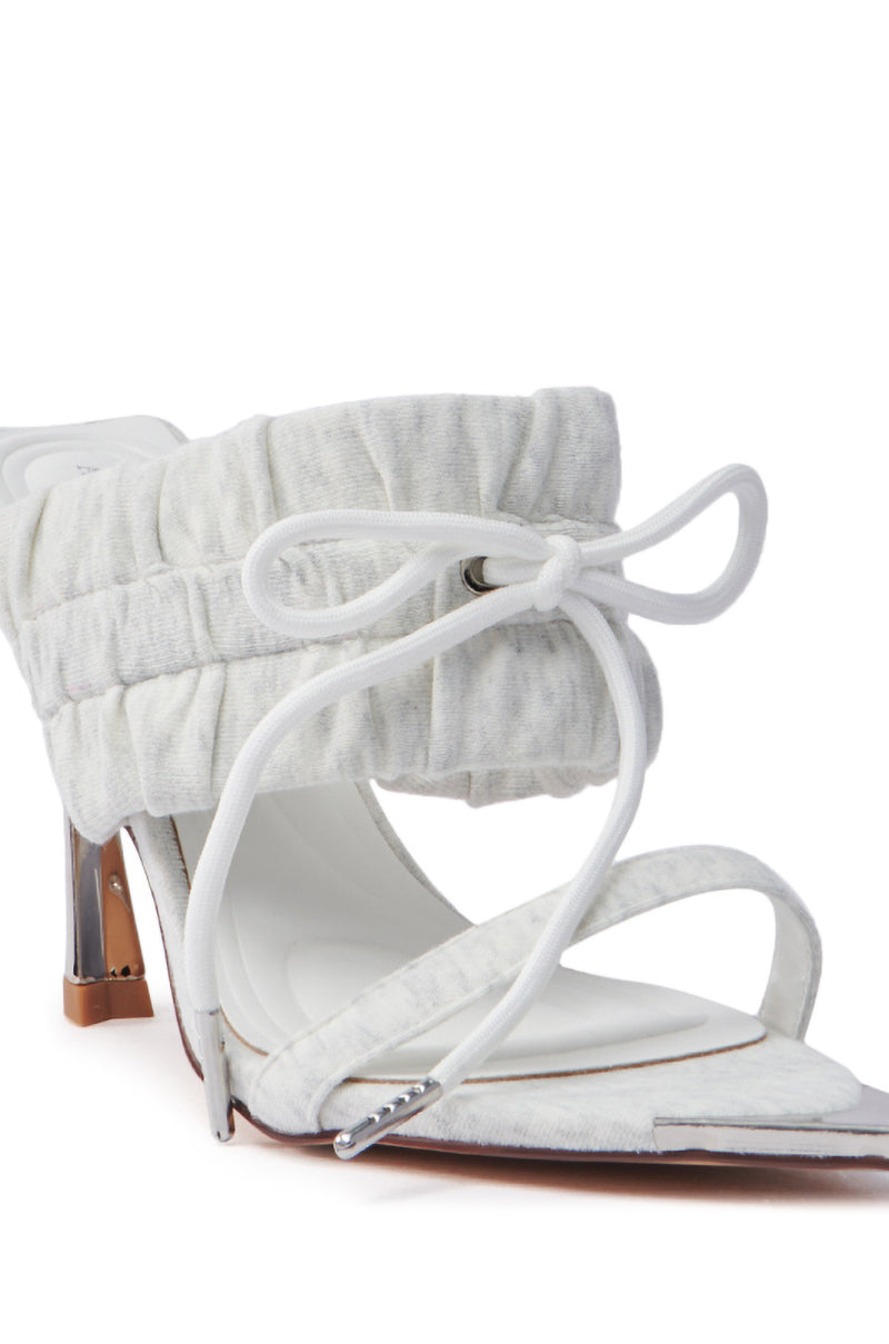 The AZALEA WANG LUNETTE GREY SANDAL is an elegant shoe with an open pointed toe, a ruched band and decorative bow at the ankle, thin straps over the toes, and a sleek metallic stiletto heel.