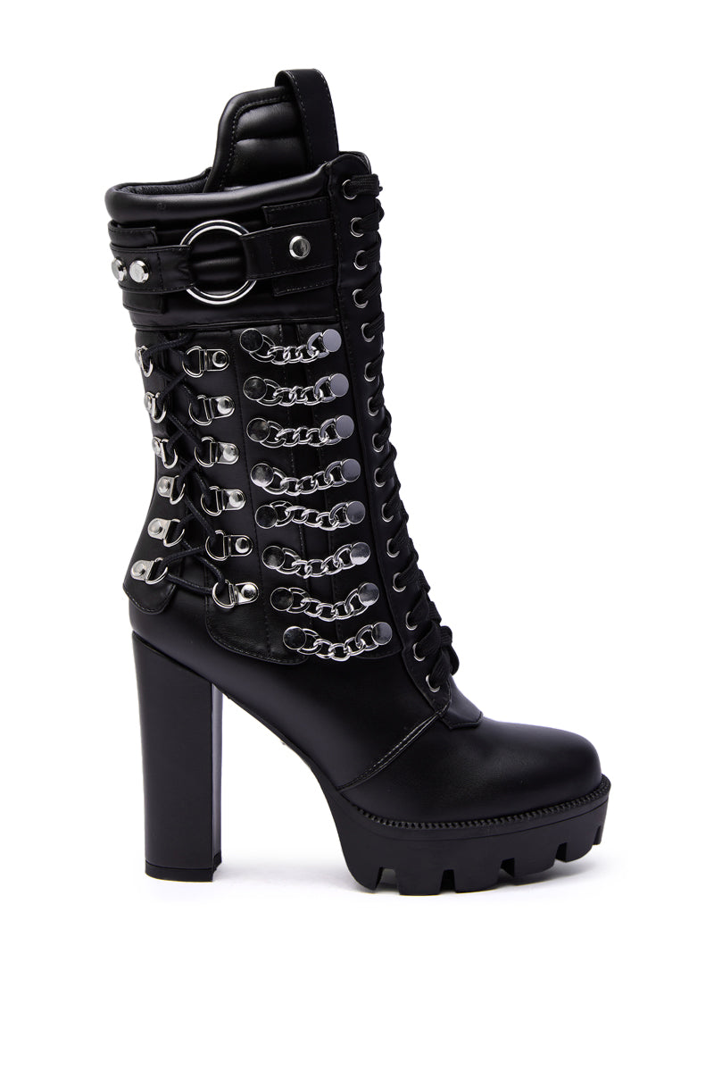 The AZALEA WANG LUUK Black Metal Hardware Embellished Chunky Bootie features black faux leather, a chunky platform sole, lace-up front, silver chain and buckle details, metal hardware accents, and decorative side hooks.