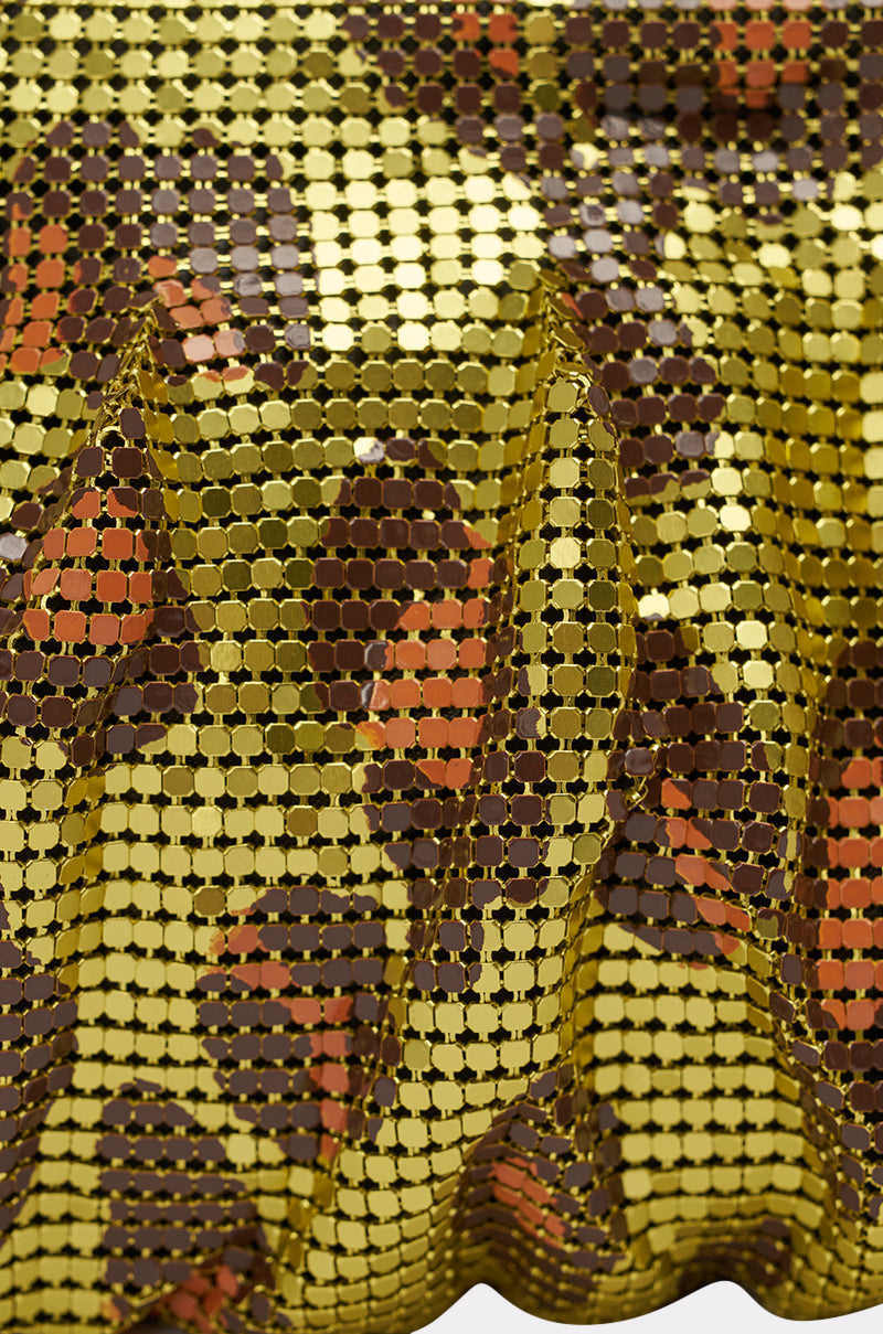 Close-up of shiny, gold sequin fabric in brown, black, and orange camo tones, draped in folds for texture—reminiscent of the TAKE A TRIP CHAINMAIL CLUTCH. 4