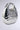 The LOVE MY VIBE HAMMERED CHROME PURSE features a shiny metallic silver finish, rounded pebble-like shape, hammered texture, large circular handle, and sleek reflective surface for a chic statement look.