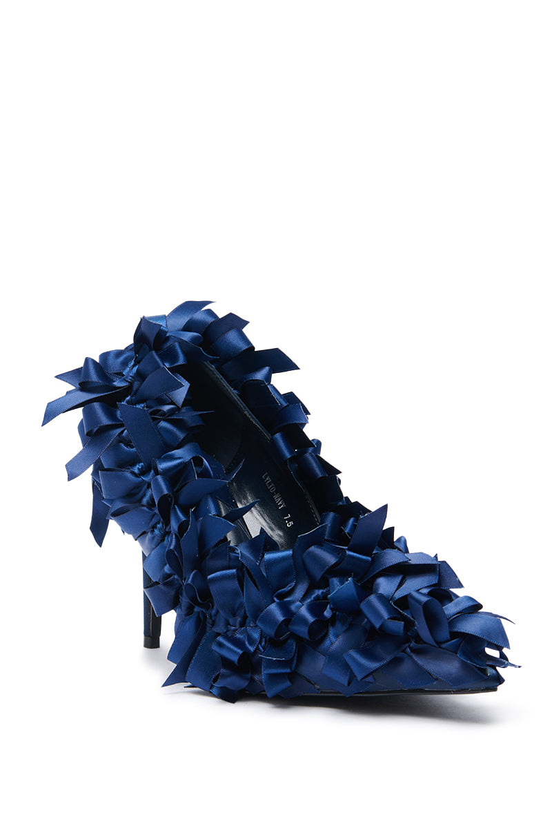 The AZALEA WANG LYLIO NAVY BOW EMBELLISHED PUMP is a high-heeled satin stiletto featuring a pointed toe and decorated with multiple shiny dark blue ribbon bows for a textured, eye-catching look.