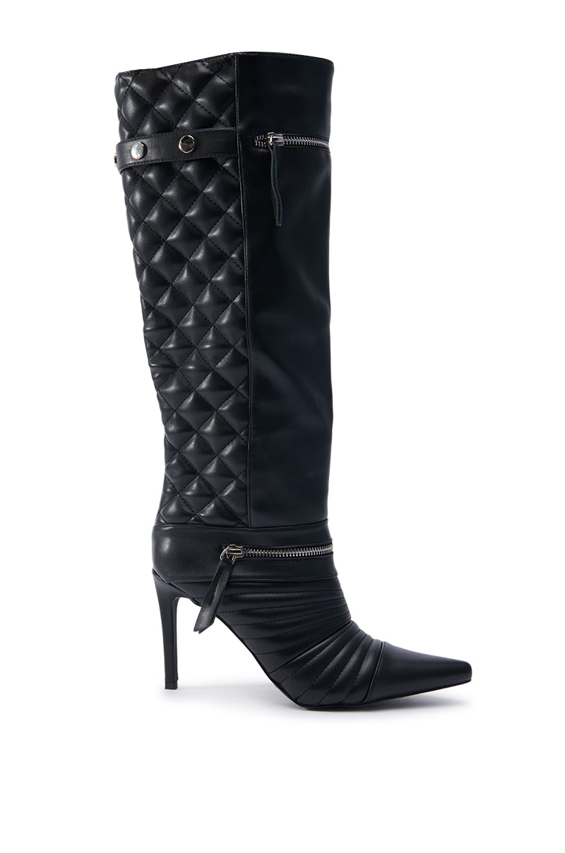 The AZALEA WANG LYRICAL BLACK STILETTO BOOT is a knee-high design in black, highlighted by a pointed toe and a quilted faux leather pattern on the upper section. It features two decorative zippers and a button detail near the top for added style.