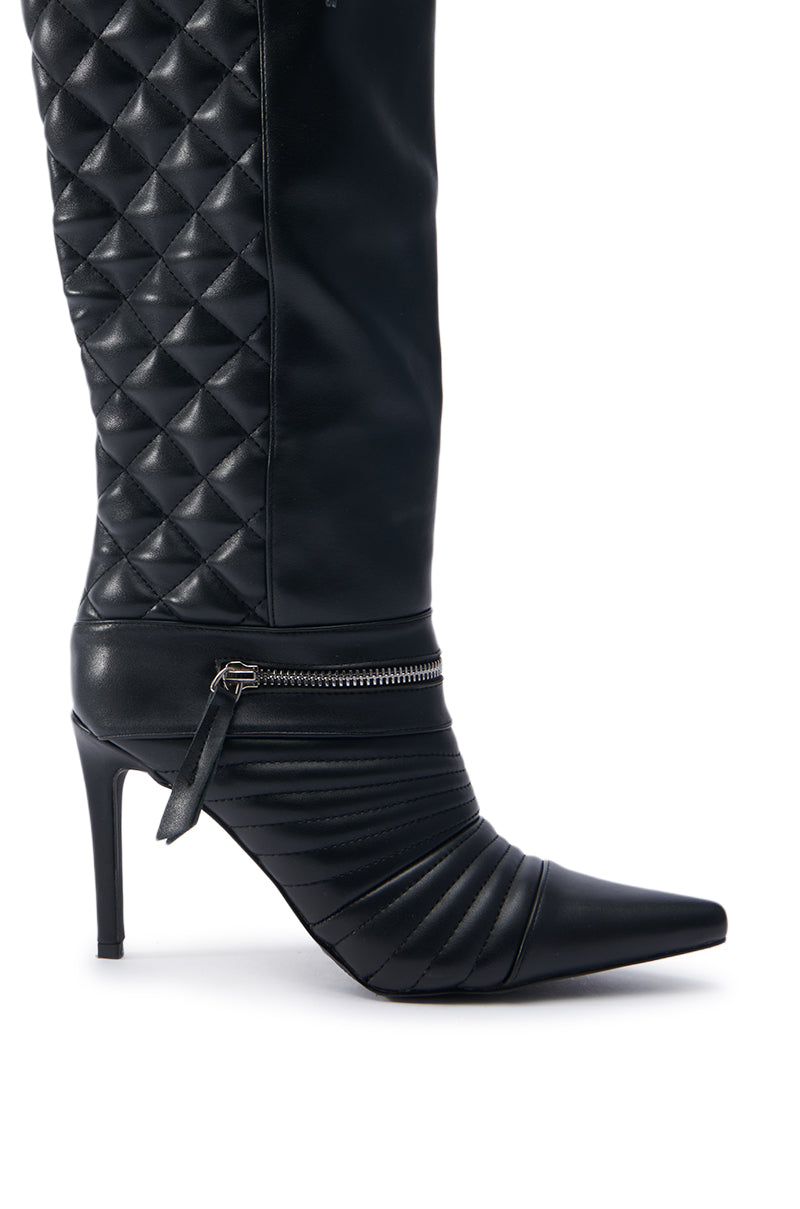 Introducing the AZALEA WANG LYRICAL BLACK STILETTO BOOT, featuring a sophisticated black finish with quilted faux leather detailing and a convenient side zipper. This knee-high silhouette showcases a pointed toe paired with a high stiletto heel, seamlessly merging elegance and edge.