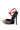 The AZALEA WANG LYSANDER BLACK MULTI PUMP STILETTO features black patent faux leather, a pointed toe, chunky gemstone embellishments, a red ankle strap, and a vibrant red inner lining.