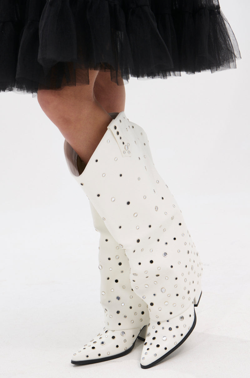 A person poses with legs crossed against a plain white background, wearing a black tulle skirt and the AZALEA WANG MADLOCK WHITE EMBELLISHED WESTERN BOOT.